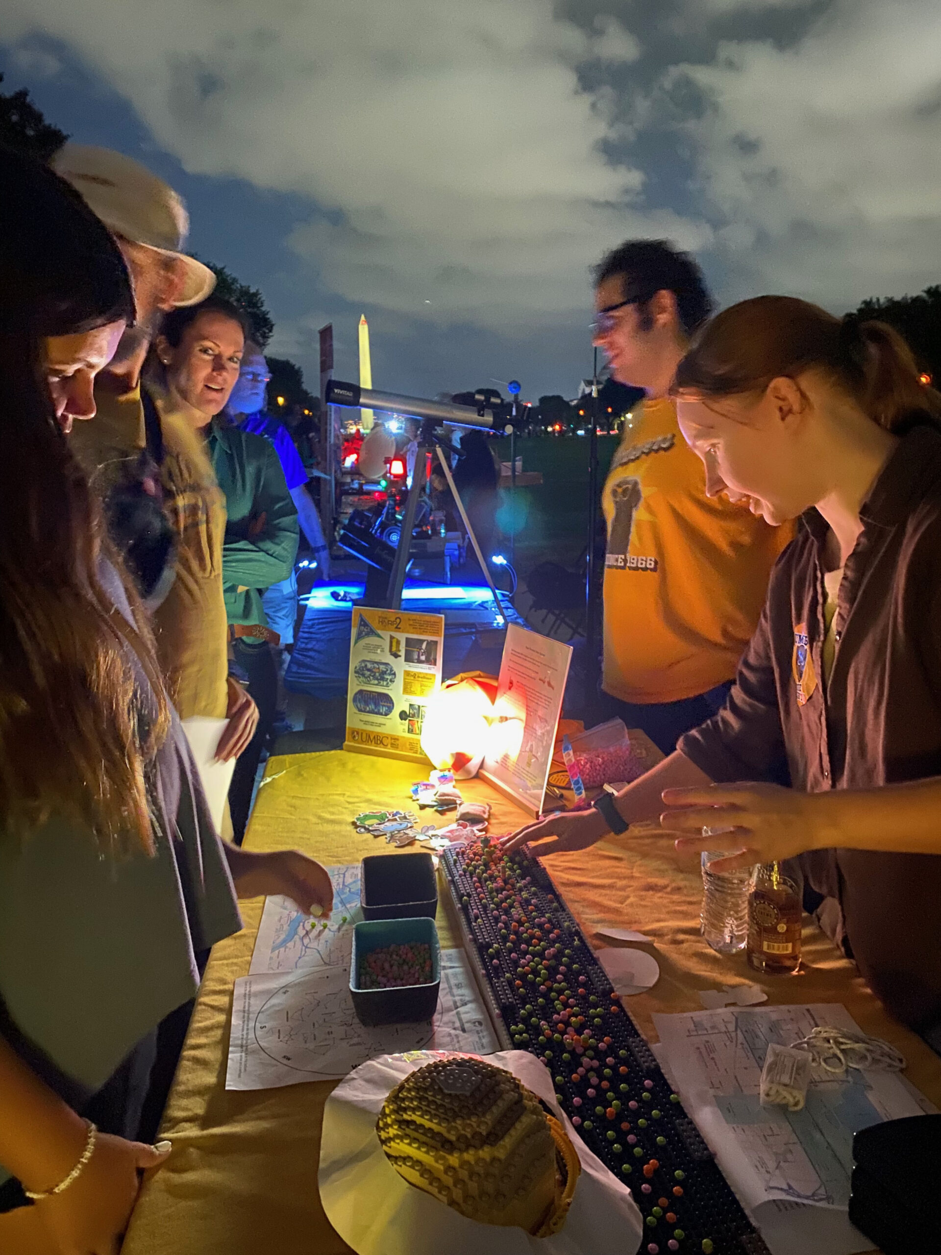 photo of dakota wolf explaining experiment to festival goers
